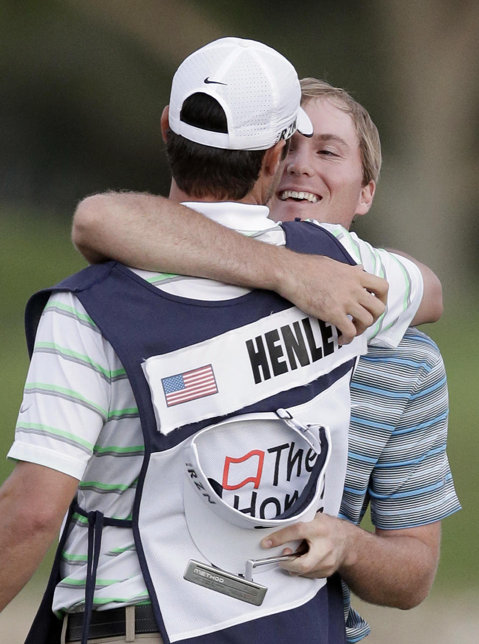 Golfer Russell Henley, right, hugs his caddie after winning the Honda Classic golf tournament on Sunday, March 2, 2014, in Palm Beach Gardens, Fla. (AP Photo/Wilfredo Lee)