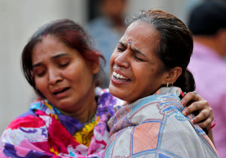 Women mourn the death of a relative after a commuter train traveling at high speed ran through a crowd of people on the rail tracks on Friday, outside a hospital in Amritsar, India, October 20, 2018. REUTERS/Adnan Abidi