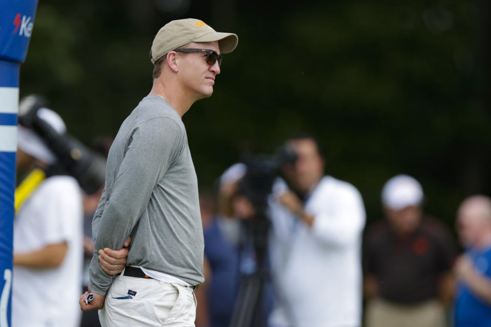 Former Indianapolis Colts quarterback Peyton Manning watches a joint practice of the Cleveland Browns at the Colts' NFL football training camp in Westfield, Ind., Thursday, Aug. 15, 2019. (AP Photo/Michael Conroy)