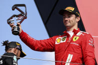 Ferrari driver Charles Leclerc of Monaco stands on the podium after finishing second in the British Formula One Grand Prix, at the Silverstone circuit, in Silverstone, England, Sunday, July 18, 2021. (Lars Baron/Pool photo via AP)