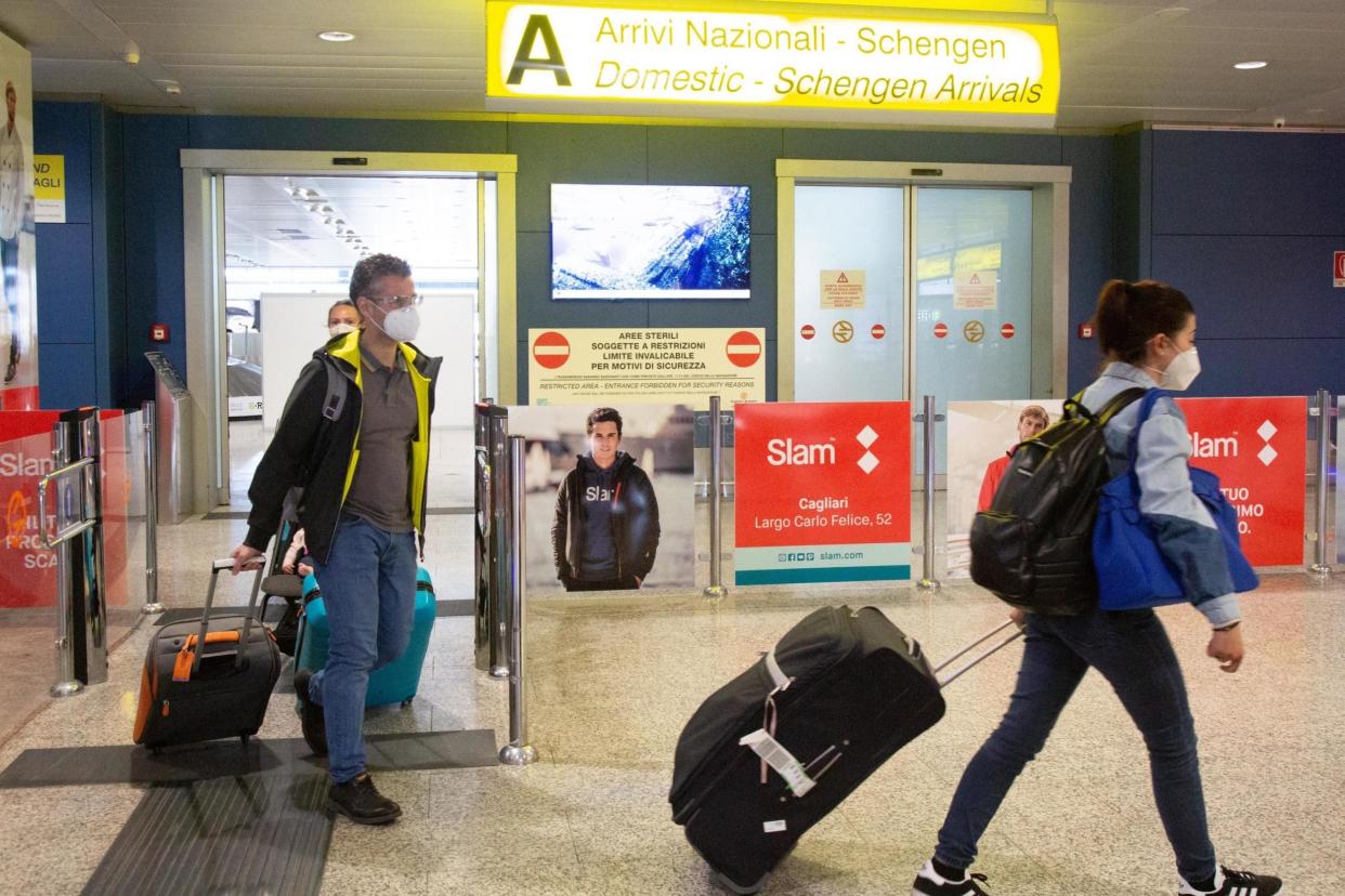 Passengers arrive at Cagliari-Elmas airport, in Cagliari, Italy,: EPA