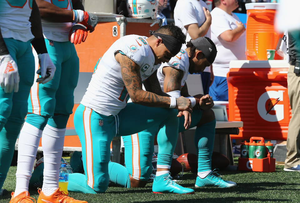 Kenny Stills and Albert Wilson of the Miami Dolphins kneel during the national anthem at Gillette Stadium in Foxborough, Massachusetts, on Sept. 30, 2018. (Photo: Jim Rogash via Getty Images)