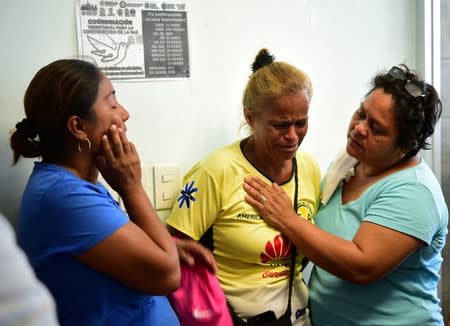 A woman reacts as she waits for the news about her relative after an arson attack by suspected gang members on a bar in the southern Mexican port of Coatzacoalcos