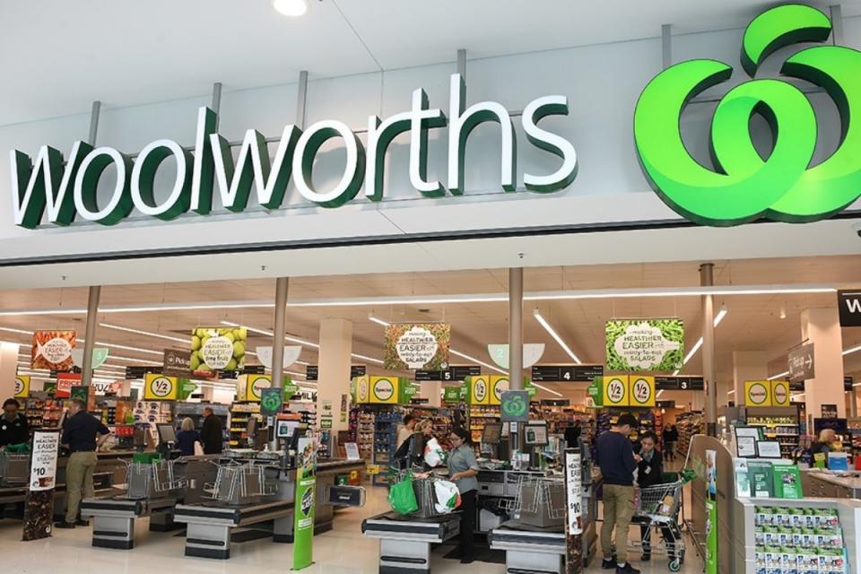 Shoppers buying groceries at Woolworths store checkout