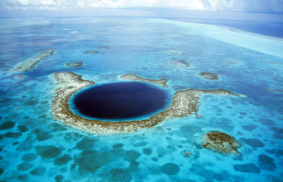 <b>The Great Blue Hole in Belize</b> - A large submarine sinkhole which is over 984 feet across and 407 feet deep. The sinkhole was formed during several episodes of quaternary glaciation when sea levels were much lower. (Kurt Amsler/Ardea/Caters News)