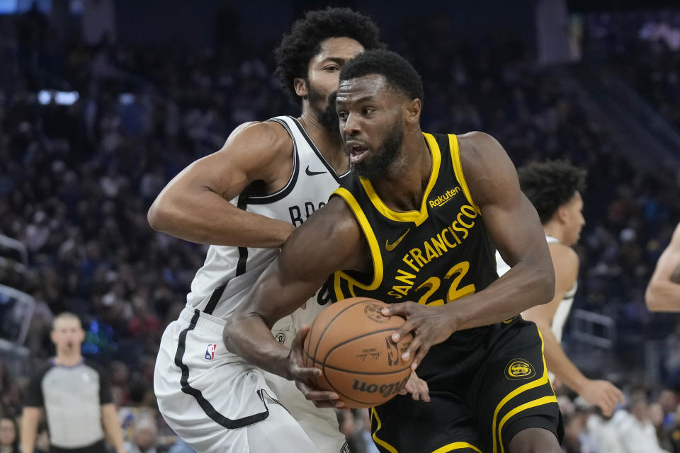 Golden State Warriors forward Andrew Wiggins (22) drives to the basket against Brooklyn Nets guard Spencer Dinwiddie during the first half of an NBA basketball game in San Francisco, Saturday, Dec. 16, 2023. (AP Photo/Jeff Chiu)