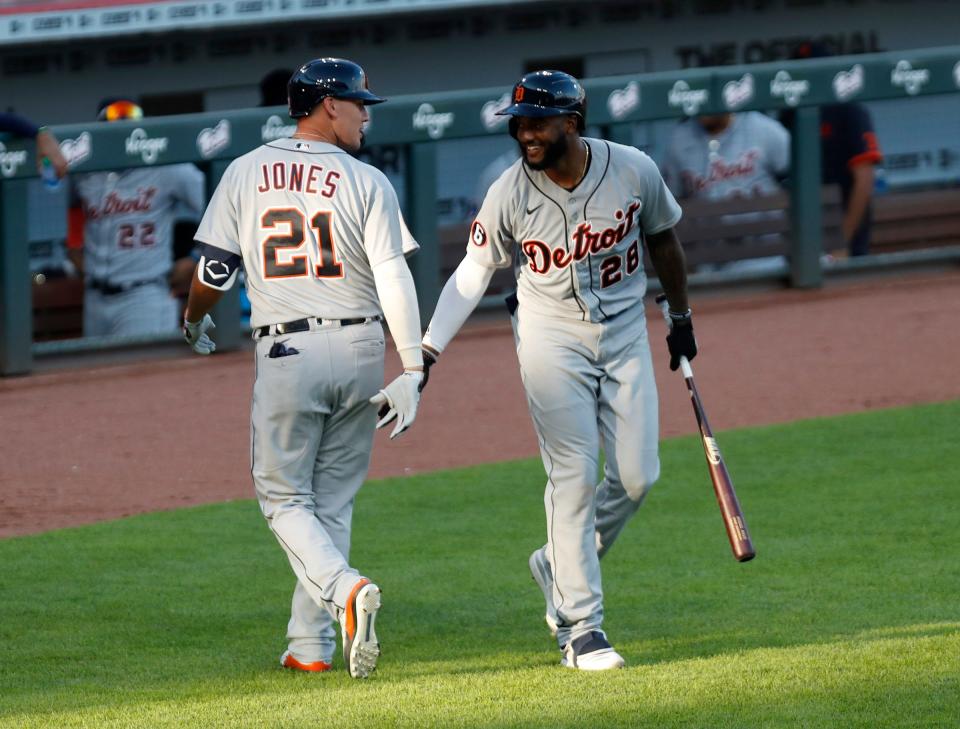 Tigers center fielder JaCoby Jones reacts with shortstop Niko Goodrum after hitting a go-ahead two-run home run during the ninth inning of the 6-4 win over the Reds on Saturday, July 25, 2020, in Cincinnati.
