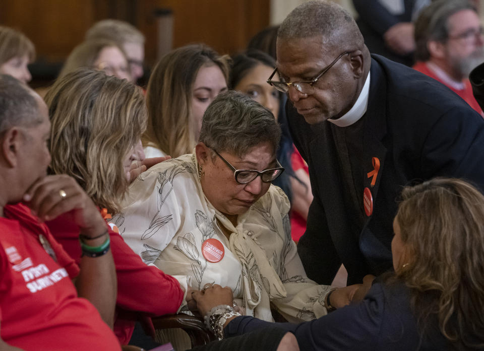 Pastor Jackie Jackson, right, an anti-violence advocate from Cincinnati, is joined by gun violence survivor Mia Livas Porter, lower right, of Los Angeles, as they comfort Rev. Sharon Risher, center, whose mother was killed in the shooting at the Emanuel AME Church shooting in Charleston, S.C., during a House Democratic forum urging the Senate to vote on a bill that would expand background checks for gun purchases, on Capitol Hill in Washington, Tuesday, Sept. 10, 2019. (AP Photo/J. Scott Applewhite)