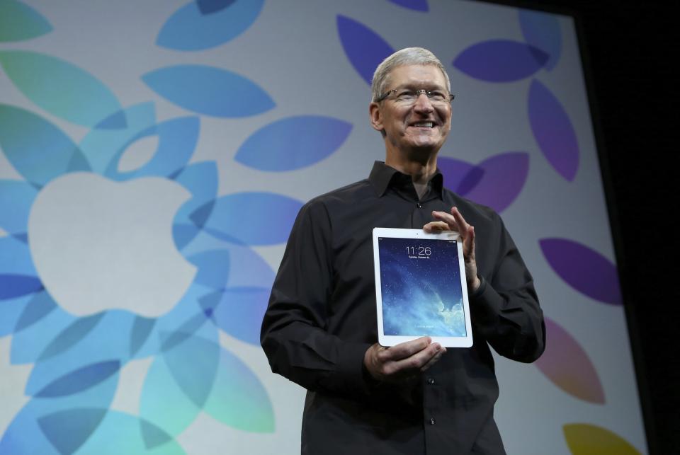 Apple Inc CEO Tim Cook holds up the new iPad Air during an Apple event in San Francisco