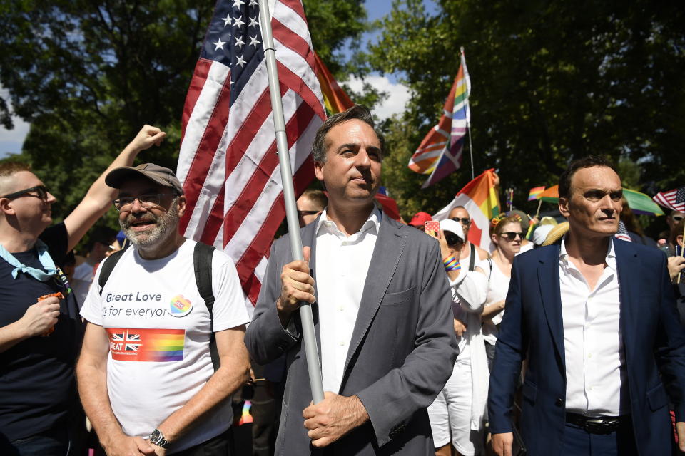 US Ambassador to Hungary David Pressman holds his country's flag as he participates in the 28th Budapest Pride parade in Budapest, Hungary, Saturday, July 15, 2023. (Tamas Kovacs/MTI via AP)