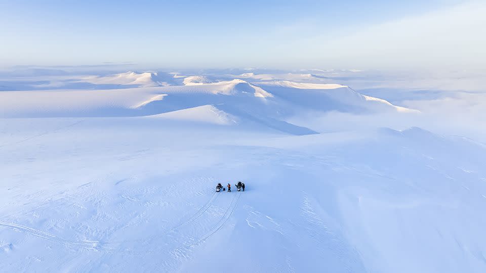 Ledoux is attracted by the immense and endless Arctic landscape.  Here, he and a colleague are pictured on snowmobiles on the east coast of Svalbard during winter. - Florian Ledoux