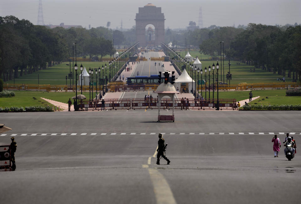 A paramilitary force soldier walks across Rajpath that was renamed Kartavya Path in New Delhi, Sunday, Sept. 11, 2022. On Thursday, Sdpt. 8, 2022, India’s Prime Minister Narendra Modi urged the country to shed its colonial ties in a ceremony to rename Rajpath, a boulevard that was once called Kingsway after King George V, Modi called it a "symbol of slavery" under the British Raj. (AP Photo/Manish Swarup)