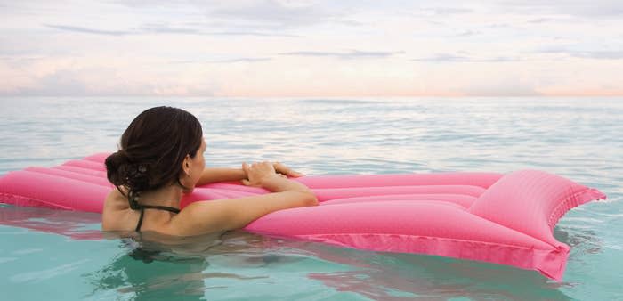 woman floating in the ocean alone