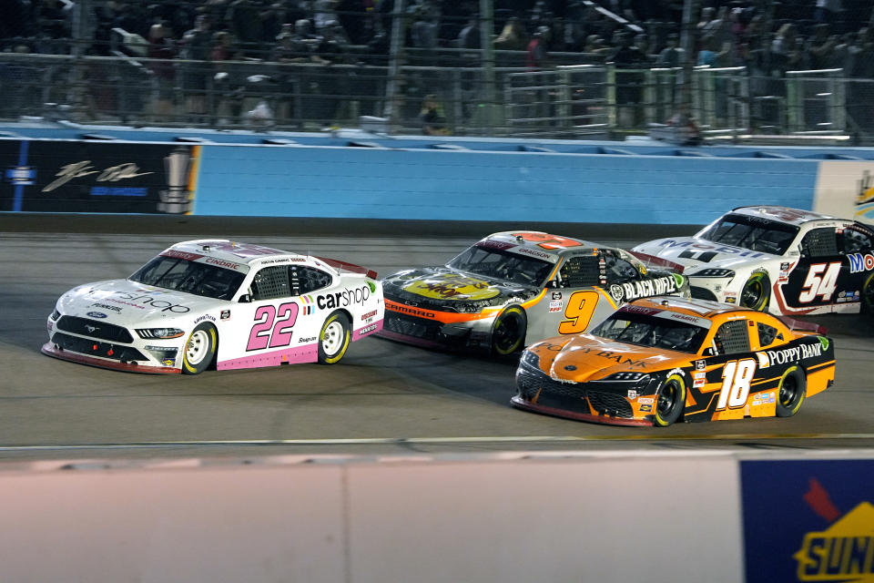 Austin Cindric (22), Noah Gragson (9), and Daniel Hemric (18) drive during the NASCAR Xfinity Series auto race Saturday, Nov. 6, 2021, in Avondale, Ariz. (AP Photo/Rick Scuteri)