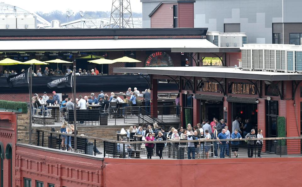 People eats and drink on the rooftop at Jason Aldean’s Kitchen and Rooftop Bar on lower Broadway in downtown Nashville on April 4, 2019.