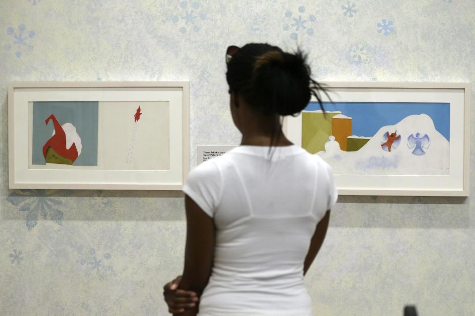 In this Friday, July 19, 2013 photo, a visitor views illustrations at The Snowy Day and The Art Of Ezra Jack Keats exhibition at the National Museum of American Jewish History, in Philadelphia. The exhibit opened July 19. (AP Photo/Matt Rourke)