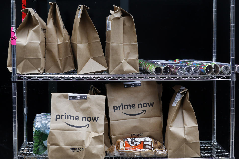 In this Wednesday, Dec. 20, 2017, photo, Amazon Prime Now bags are ready for delivery, at the Amazon warehouse in New York. (AP Photo/Mark Lennihan)