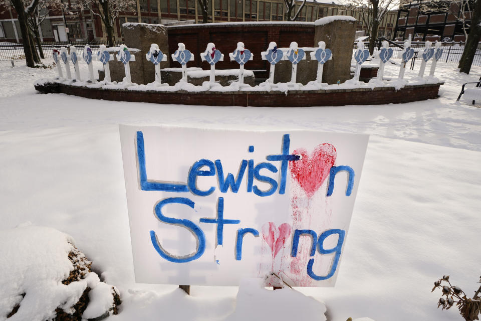 Recent snowfall coats crosses at one of several memorials for the victims of last month's mass shooting in Lewiston, Maine, Tuesday, Dec. 5, 2023. With winter approaching, officials began removing memorials to the 18 people killed. The items will be cataloged, archived and displayed in a museum. (AP Photo/Robert F. Bukaty)