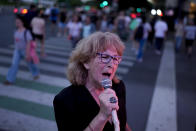 Ámbar Imoberdoff belts out a tune on a street corner in downtown Buenos Aires, Argentina, Thursday, March 7, 2024. Imoberdoff, a 72-year-old retiree, started singing boleros and tangos in one of the busiest corners of Buenos Aires, because her pension — of roughly $140 a month — is not enough to buy food, medicine and pay for taxes and public services. (AP Photo/Natacha Pisarenko)