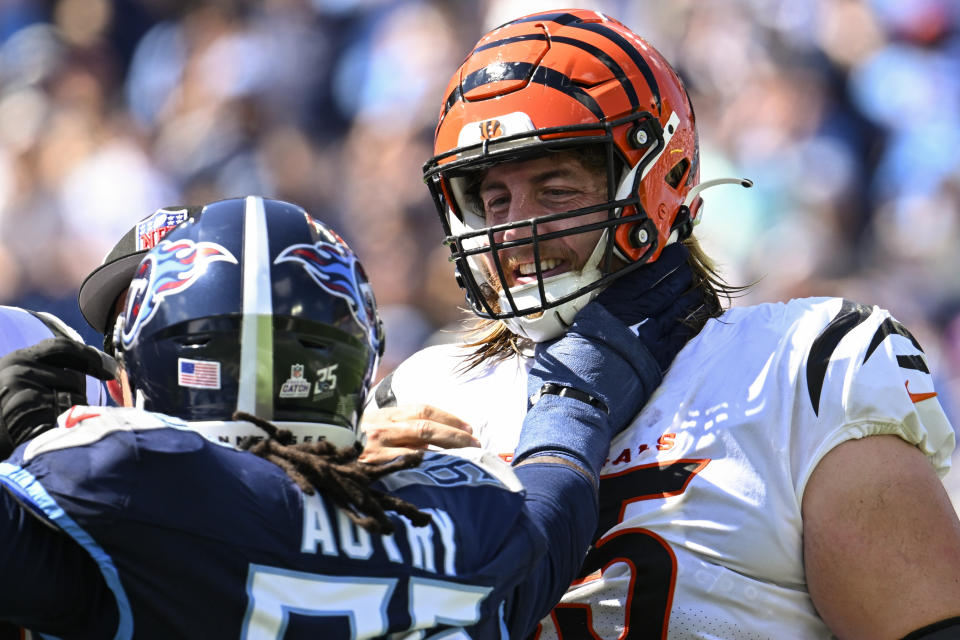 Tennessee Titans defensive end Denico Autry (96) speaks with Cincinnati Bengals guard Alex Cappa (65) during the first half of an NFL football game, Sunday, Oct. 1, 2023, in Nashville, Tenn. (AP Photo/John Amis)