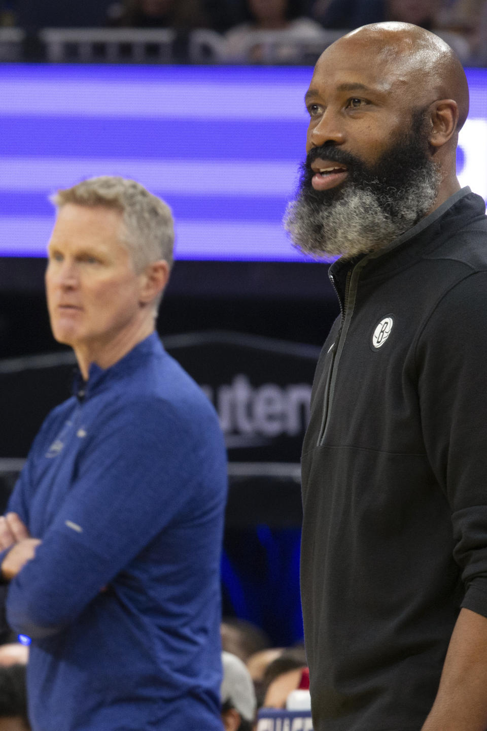 Golden State Warriors head coach Steve Kerr, left, and Brooklyn Nets head coach Jacque Vaughn watch the action during the first quarter of an NBA basketball game, Sunday, Jan. 22, 2023, in San Francisco. (AP Photo/D. Ross Cameron)