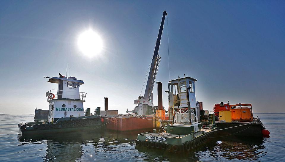 A work barge and a crane at the Long Island Bridge site prompted Quincy officials to visit the pier where maintenance work was performed Thursday, Sept. 7, 2023.