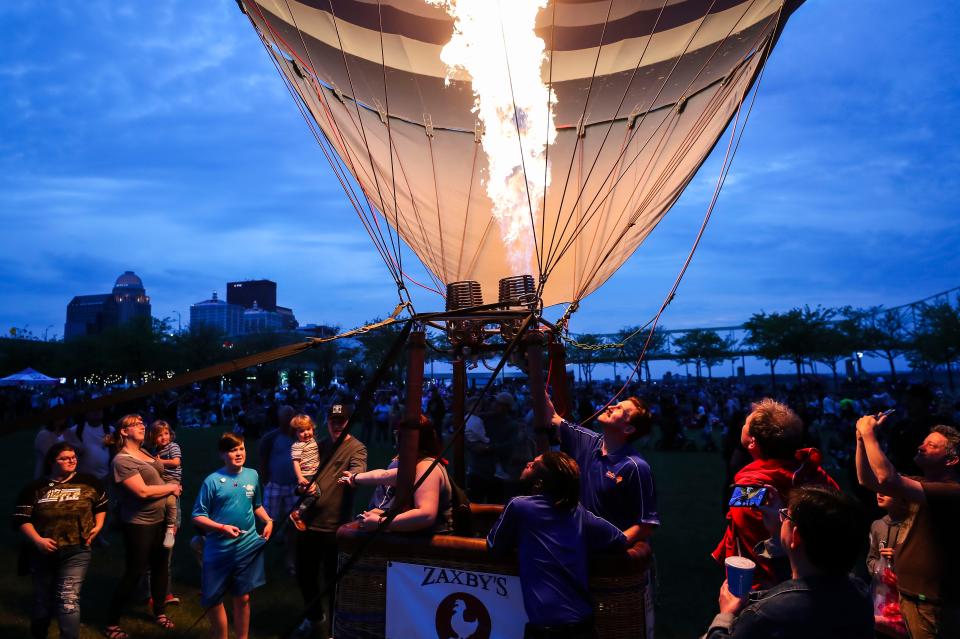 The glowing balloons drew a crowd of thousands on a warm Spring night at the Kentucky Derby Festival Great Balloon Glow at the Kroger Fest-a-Ville on the Waterfront Friday evening. April 29, 2022