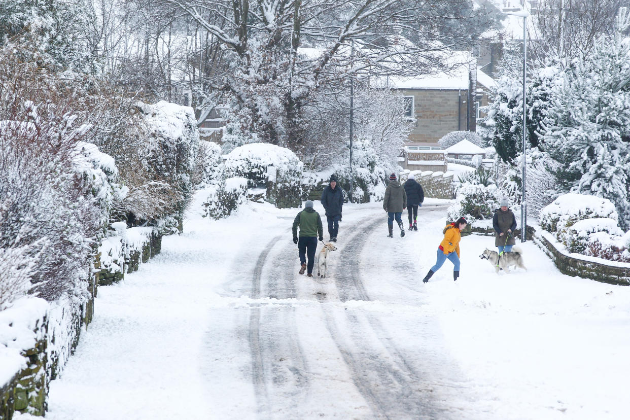  People walk along a snow-covered lane in West Yorkshire. Heavy snow fell overnight in West Yorkshire, causing dangerous driving conditions. (Photo by Adam Vaughan / SOPA Images/Sipa USA) 