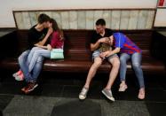 People wait for the train at a metro station after a World Cup soccer match in Moscow, Russia July 1, 2018. REUTERS/Gleb Garanich