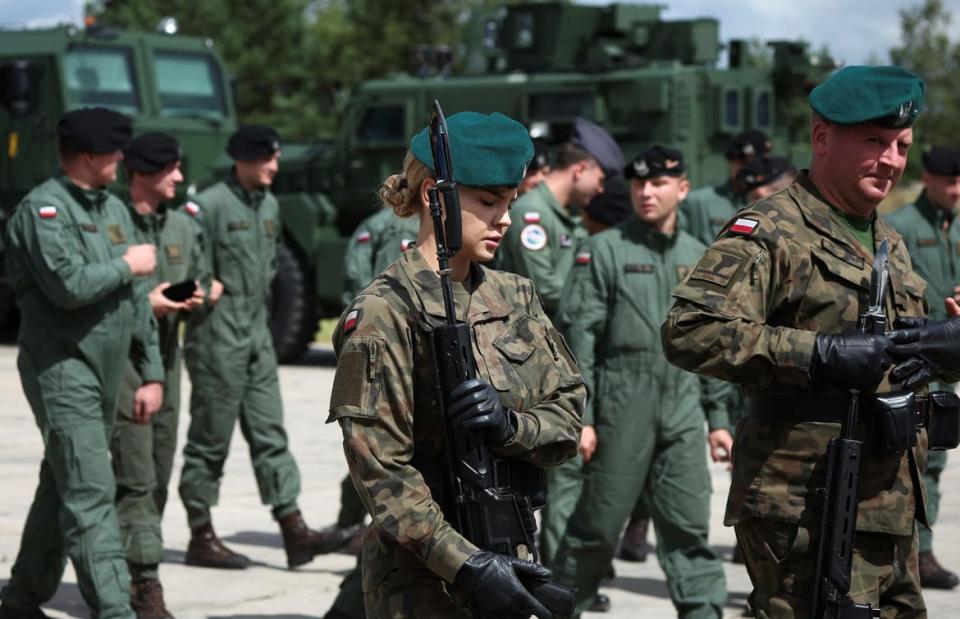 A photo of Polish soldiers walk at Wesola military base in Warsaw, Poland.