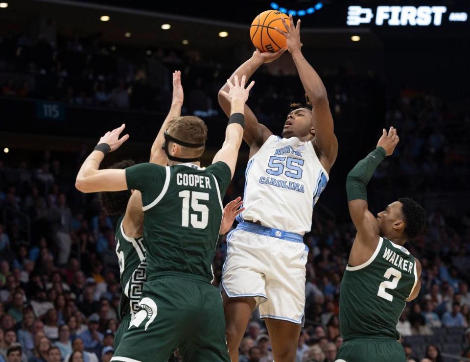 North Carolina's Harrison Ingram (55) shoots a basket in the first half against Michigan State's Carson Cooper (15) and Tyson Walker (2) during the second round of the NCAA Tournament at Spectrum Center in Charlotte, NC, on Saturday, March 23, 2024.
