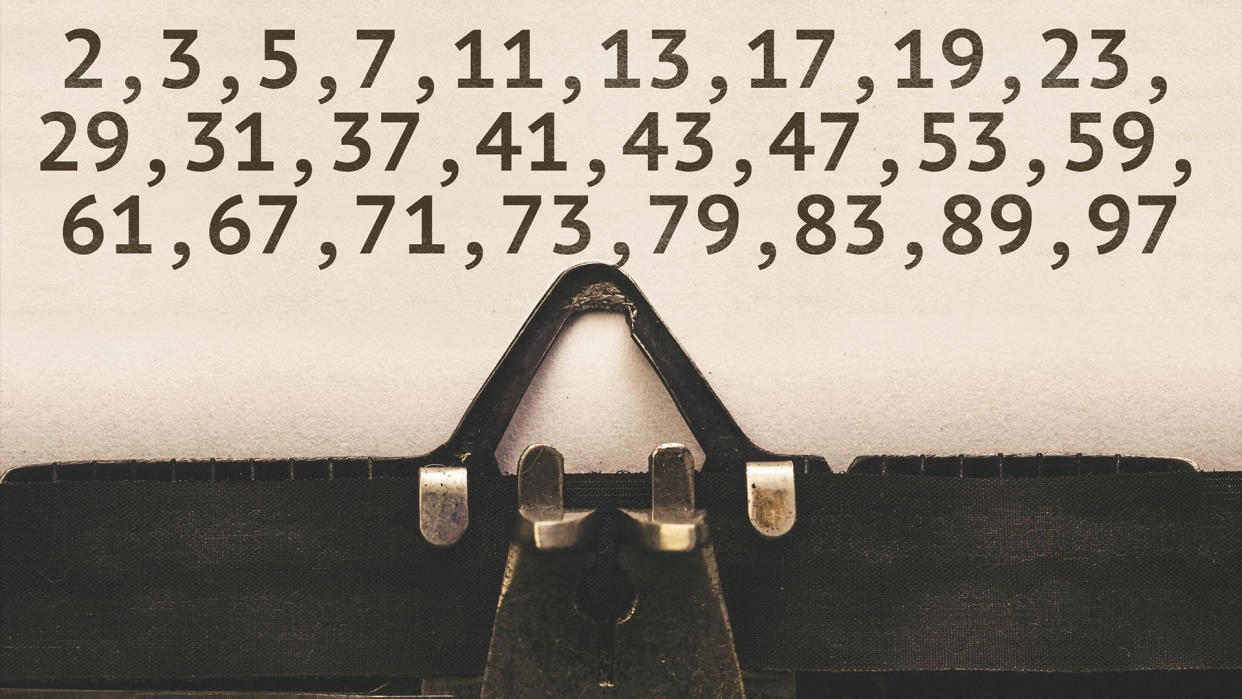  List of prime numbers below 100 on paper in vintage type writer machine from 1920s closeup with paper. 