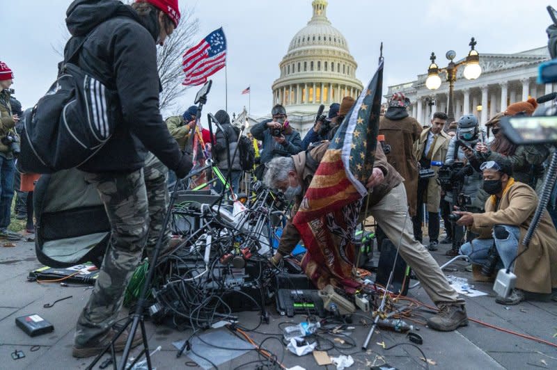 Supporters of Donald Trump destroy network video gear as hundreds of others breach the security perimeter and penetrate the U.S. Capitol on January 6, 2021. File Photo by Ken Cedeno/UPI