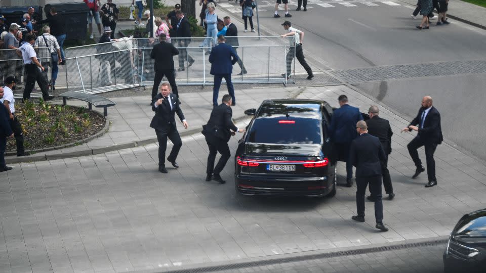 Security officers move Slovak Prime Minister Robert Fico in a car after the assassination attempt in Handlova, Slovakia, on Wednesday May 15. - Radovan Stoklasa/Reuters