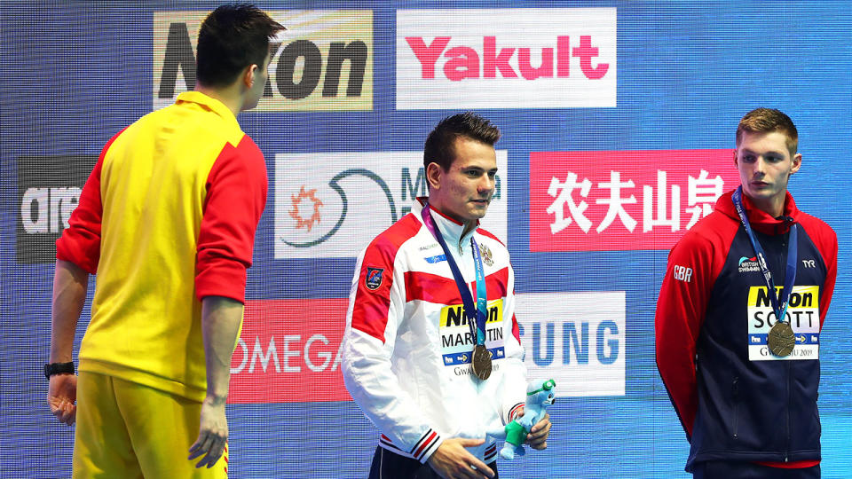 Sun Yang has words with Duncan Scott on the podium. (Photo by Catherine Ivill/Getty Images)