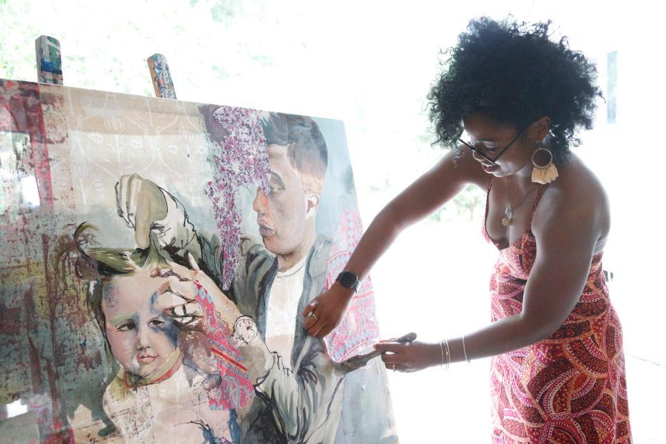 Artist Gabe Torres works in her studio.