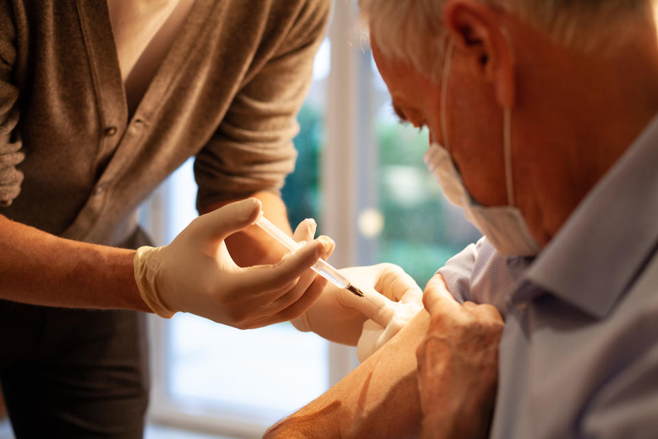 A senior man gets a flu shot