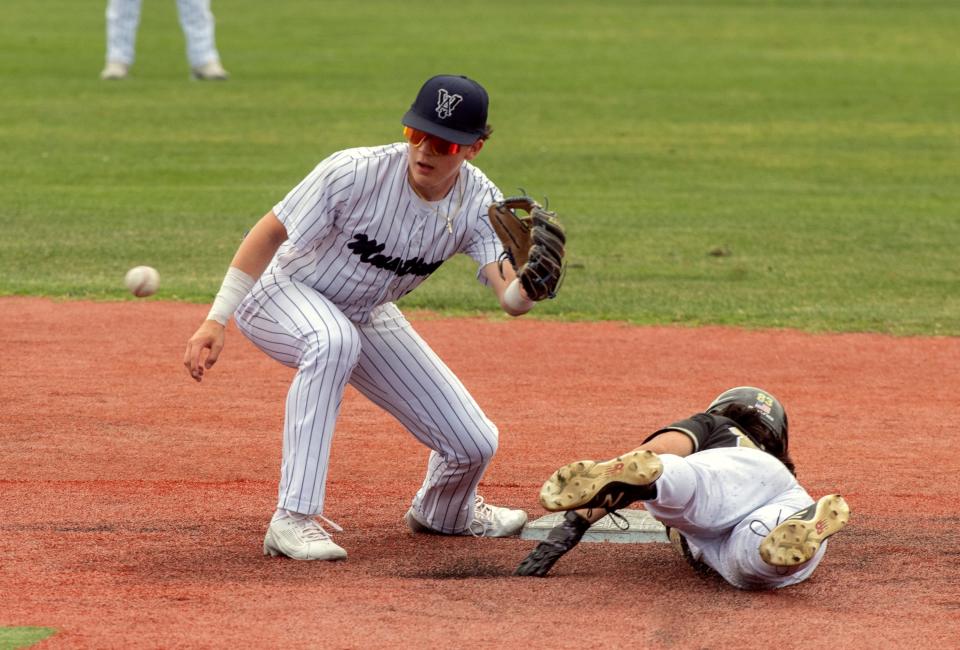 Venture Academy's Isaac Stewart waits for the throw as Millennium's Patrick Walsh safely steals second during a varsity baseball game at Billy Hebert Field in Stockton on Apr. 25, 2024.