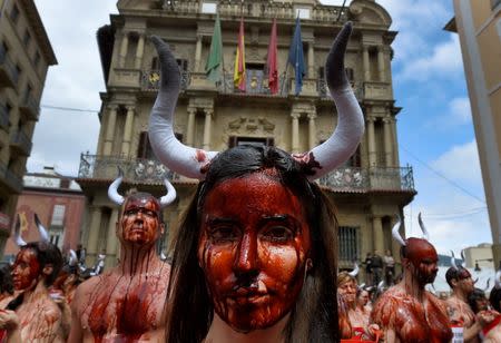 Animal rights protesters covered in fake blood demonstrate for the abolition of bull runs and bullfights a day before the start of the famous running of the bulls San Fermin festival in Pamplona, northern Spain, July 5, 2016. REUTERS/Eloy Alonso