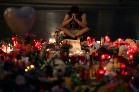 A man reacts at an impromptu memorial where a van crashed into pedestrians at Las Ramblas in Barcelona, Spain, August 20, 2017. REUTERS/Susana Vera