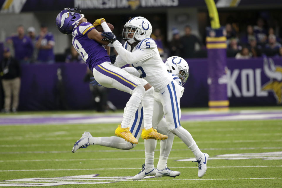 Minnesota Vikings wide receiver Justin Jefferson (18) is tackled by Indianapolis Colts cornerback Stephon Gilmore (5) during the second half of an NFL football game, Saturday, Dec. 17, 2022, in Minneapolis. (AP Photo/Andy Clayton-King)