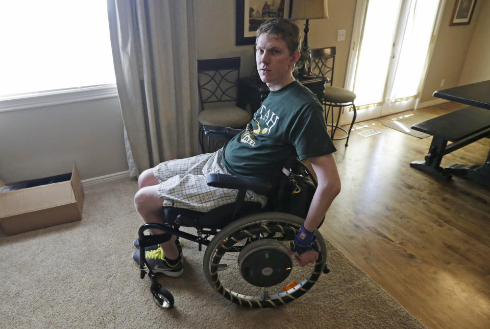 In this Wednesday, Aug. 7, 2013, photo, Stephen Merrill is shown at his home in Highland, Utah. Merrill was finishing his freshman year of college two years ago when he and a group of friends went to an indoor trampoline park in Utah for a day of flipping, jumping and bouncing. At one point, Merrill leaped from a platform into a pit full of foam blocks, and he shot right through the protective barriers and landed on his head on a trampoline and foam surface below. He broke a vertebra in his neck, and was left paralyzed from the neck down. (AP Photo/Rick Bowmer)