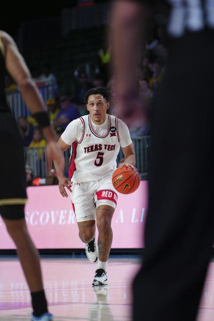 In a photo provided by Bahamas Visual Services, Texas Tech's Darrion Williams brings the ball upcourt during the second half of an NCAA college basketball game against Michigan in the Battle 4 Atlantis at Paradise Island, Bahamas, Friday, Nov. 24, 2023. (Ronnie Archer/Bahamas Visual Services via AP)