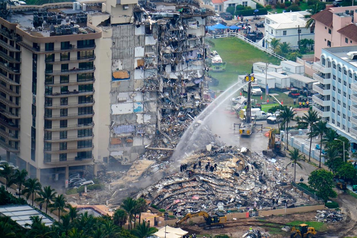 FILE - In this June 25, 2021 file photo, rescue personnel work at the remains of the Champlain Towers South condo building in Surfside, Fla.