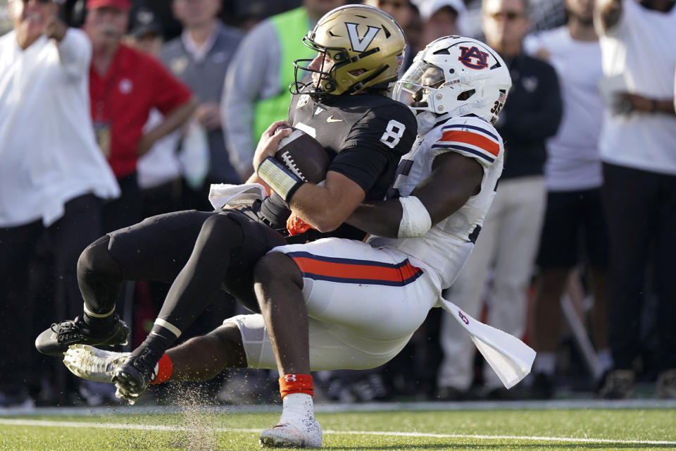 Auburn linebacker Jalen McLeod, right, tackles Vanderbilt quarterback Ken Seals (8) in the first half of an NCAA college football game Saturday, Nov. 4, 2023, in Nashville, Tenn. (AP Photo/George Walker IV)