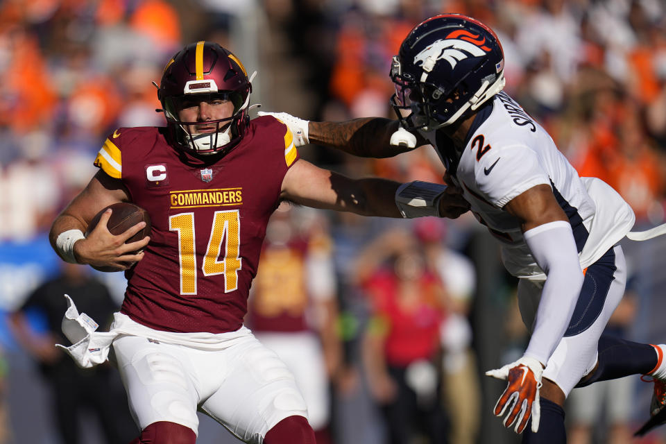 Washington Commanders quarterback Sam Howell (14) tries to get away from Denver Broncos cornerback Pat Surtain II (2) in the second half of an NFL football game, Sunday, Sept. 17, 2023, in Denver. (AP Photo/Jack Dempsey)
