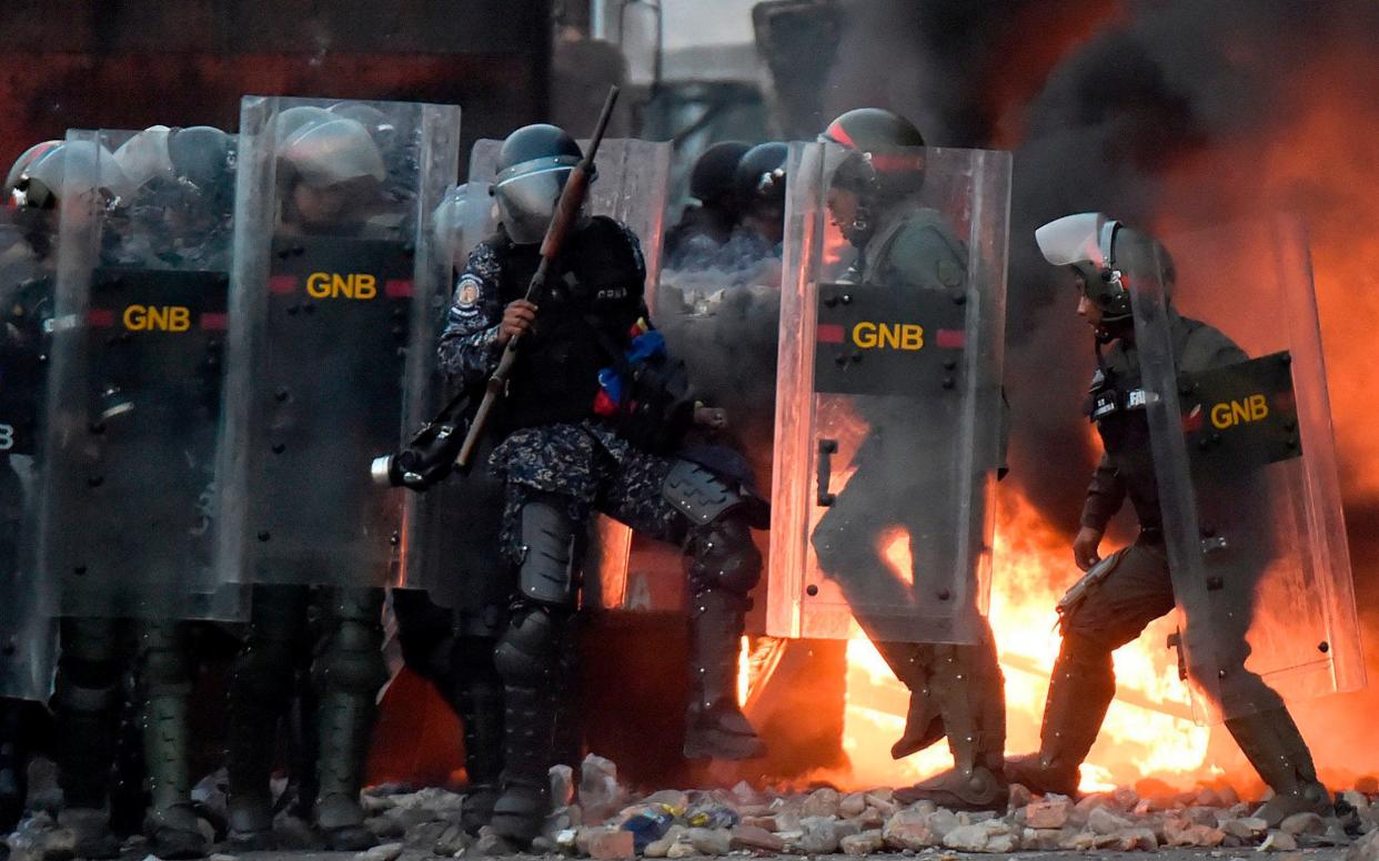 Venezuelan security forces clash with supporters of Venezuelan opposition leader Juan Guaido - AFP