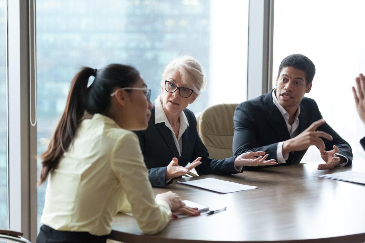 Employees dispute accusing colleague during company meeting