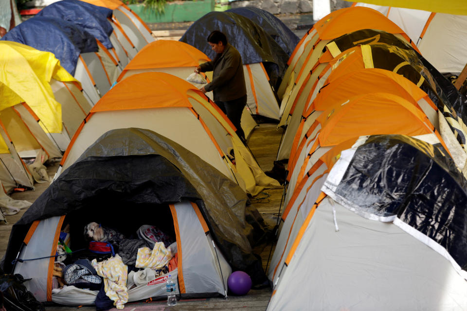 <p>A dog sits in a tent at a school turned shelter for people whose homes were damaged in an earthquake, in Mexico City, Mexico, Sept. 23, 2017. (Photo: Jose Luis Gonzalez/Reuters) </p>