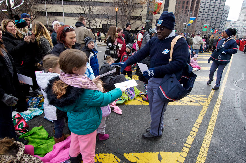 Philadelphia, PA, USA - November 27, 2014: Letter Carriers with the USPS are seen collecting mail addressed to Santa Claus during the Thanksgiving Day Parade in Philadelphia.